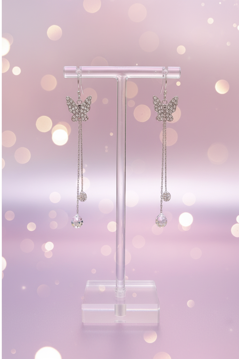 Crystal butterfly earrings on display stand