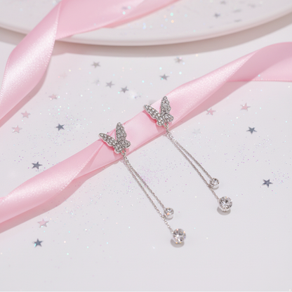 Crystal butterfly earrings on pink satin with stars