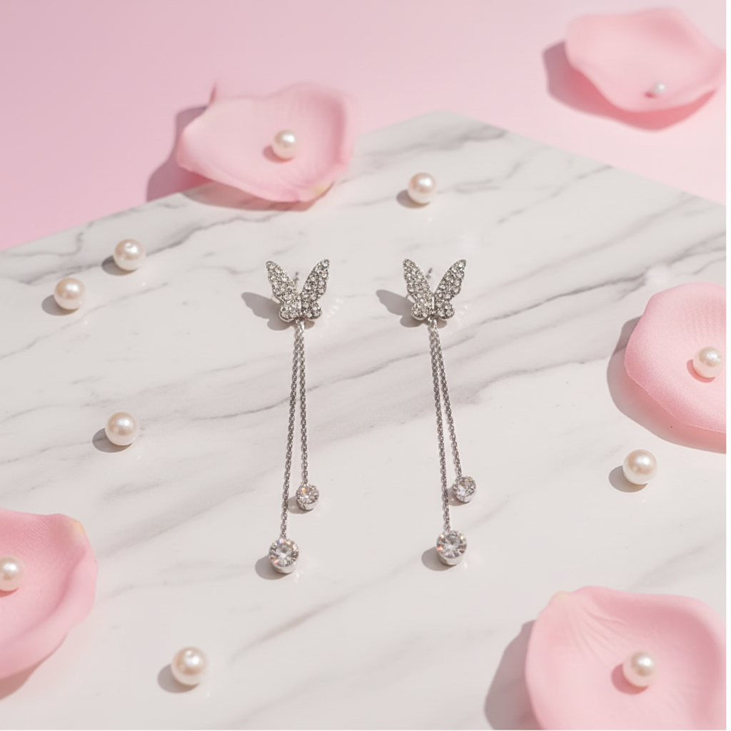 Crystal butterfly earrings pink marble flat lay