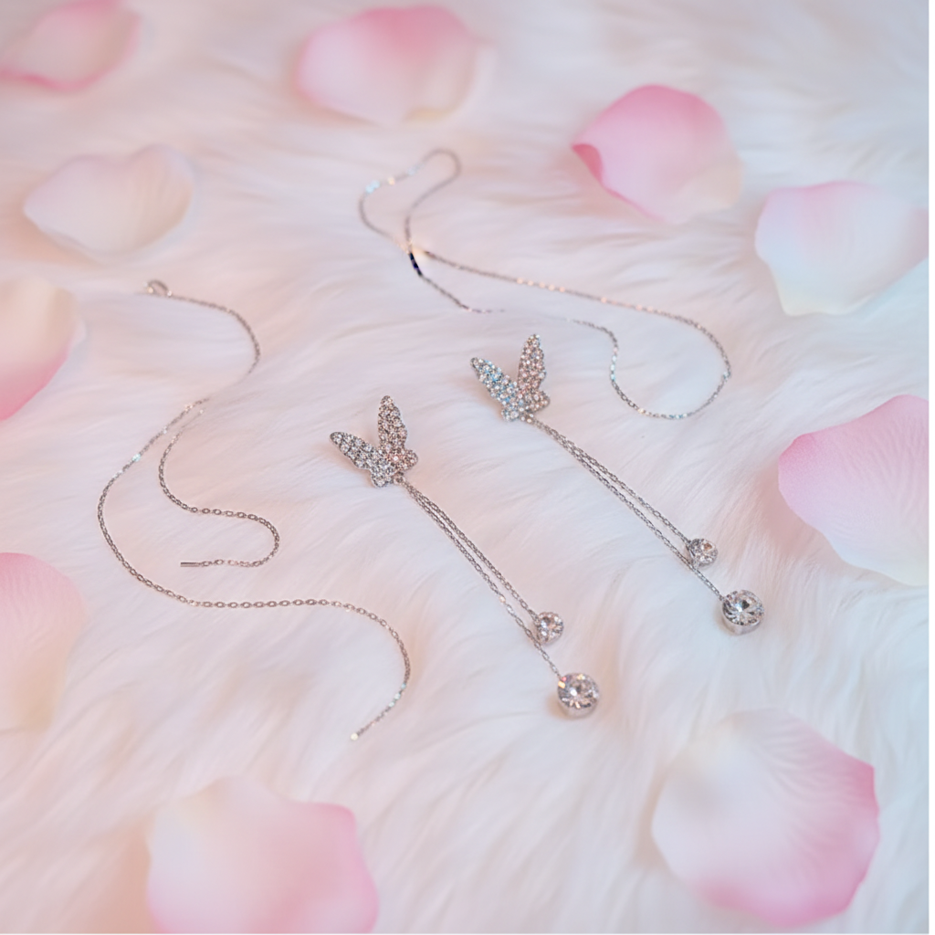 Crystal butterfly earrings fluffy floral flat lay